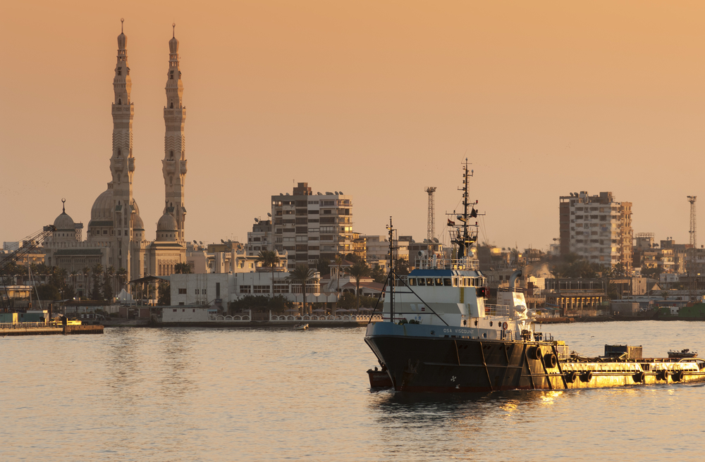 Port Said, Egypt, 2007 - The Offshore Supply Ship OSA Viscount passing north in the Suez Canal at sunset. BigRoloImages