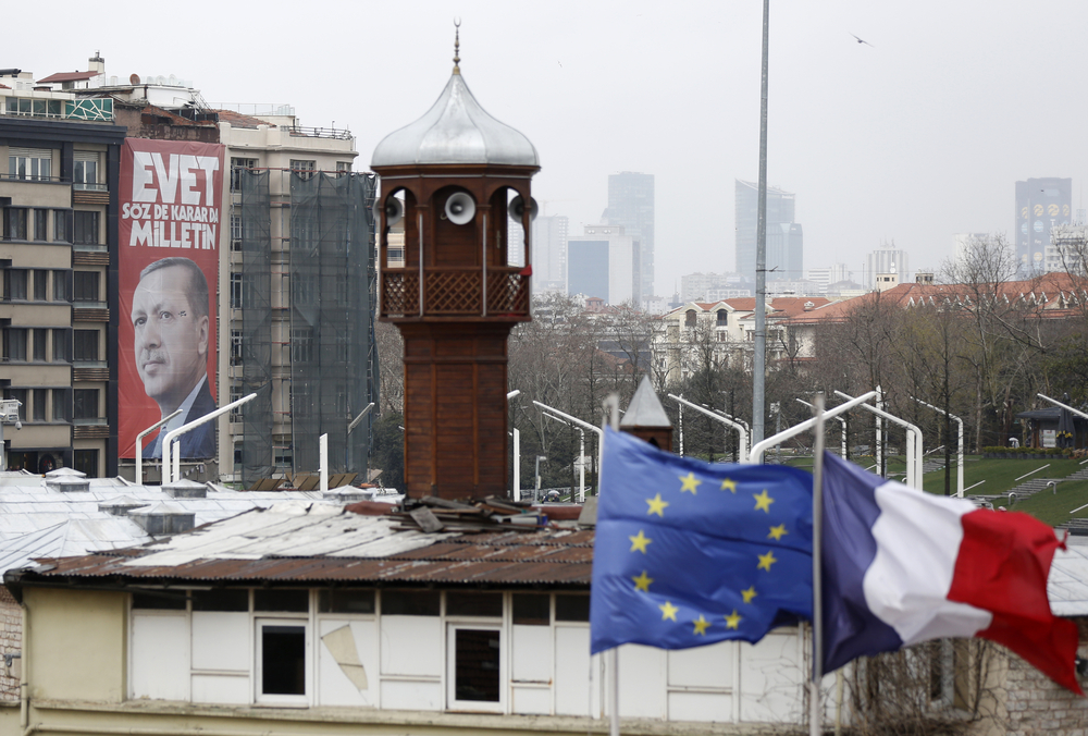 A huge poster of Turkish President Recep Tayyip Erdogan in front of the European and French flags and the Taksim mosque minaret in Istanbul. 