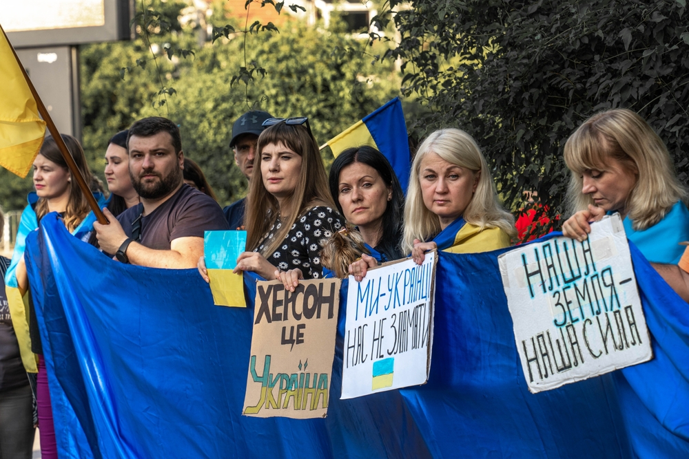 Sofia, Bulgaria, June 13, 2022: people holding Ukrainian flag and banners supporting Ukraine.