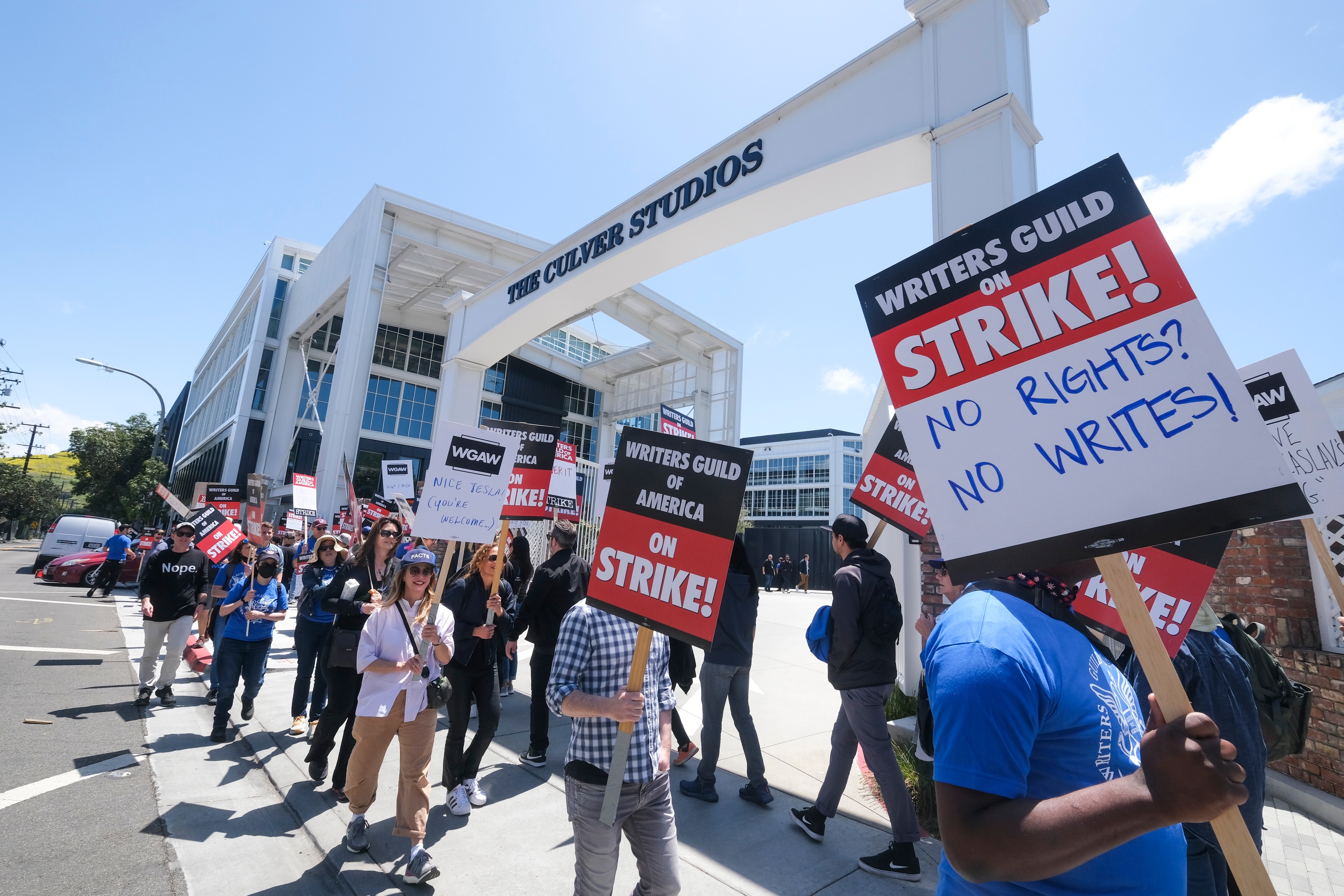 Members of WGA walk with pickets on strike outside the Culver Studio, Tuesday May 2, 2023 in Culver City, California.