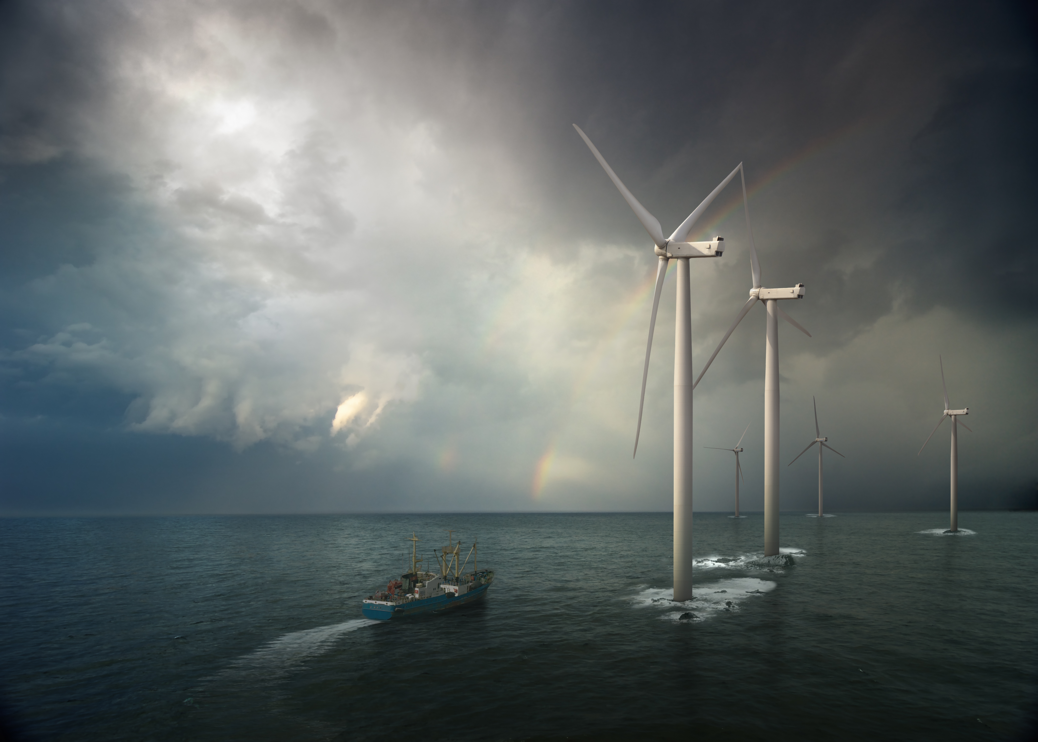 Windmill in the ocean. Rising storm.