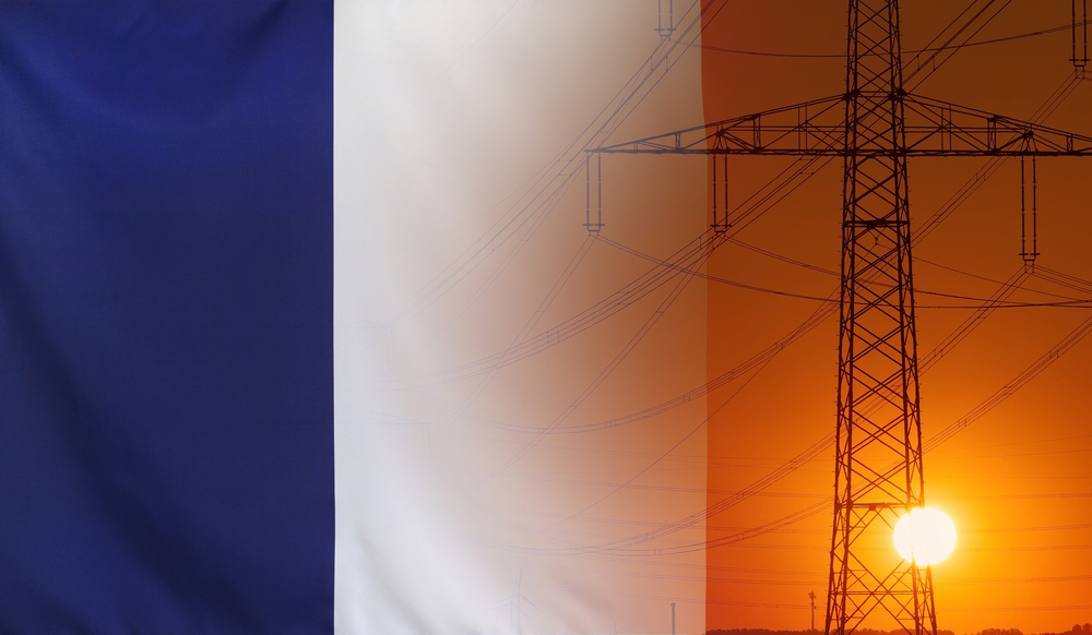 Shutterstock / Concept Energy Distribution, Flag of France with high voltage power pole during sunset