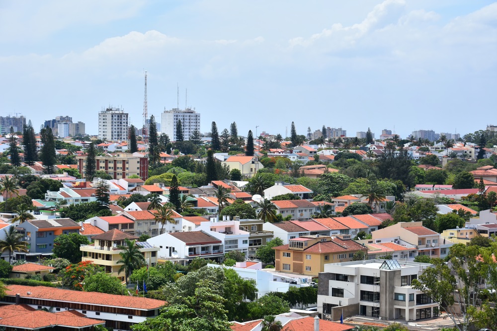 A colorful elevated view of houses in a residential area in Maputo, the capital of Mozambique with tall buildings in the background